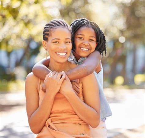 Hug Mother And Daughter Portrait In Park Relaxing Together On Summer Hug Mother And Daughter Portrait In Park Relaxing Together On Summer