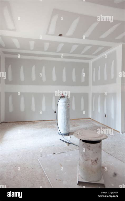 New Home Under Construction The Sheetrock Is Up And Mudded Stock New Home Under Construction The Sheetrock Is Up And Mudded Stock